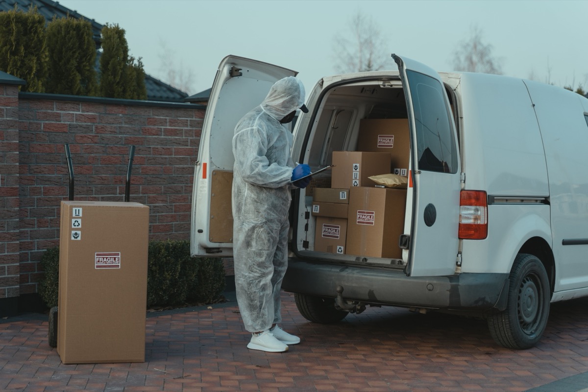 Warehouse worker checking outgoing packages during a dispatch operation