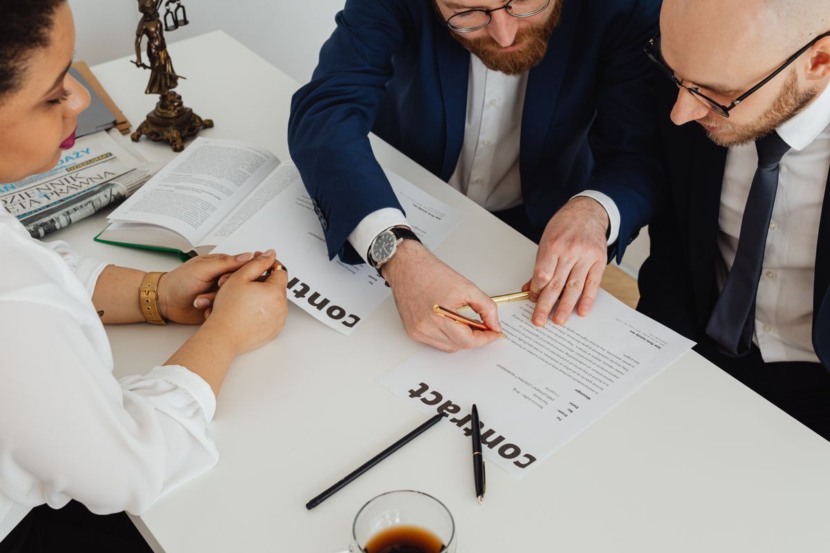 Business professionals reviewing a contract together at a desk